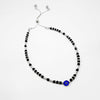 Silver Beaded anklet with black and blue beads on a white background