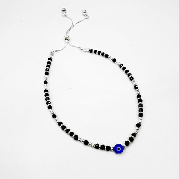 Silver Beaded anklet with black and blue beads on a white background