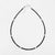 Black beaded necklace on a white background