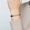 Bracelet on a wrist with a neutral background