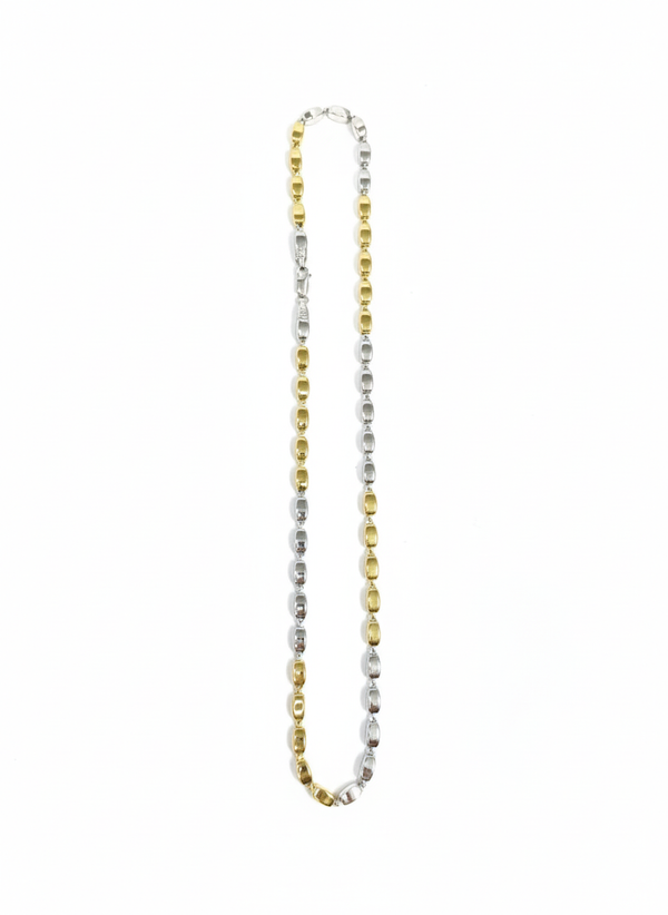 Two-tone gold and silver necklace on a white background