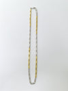 Two tone necklace, one gold and one silver, on a white background