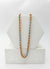 Two-tone chain necklace in silver, rose gold, and gold on a white stand.