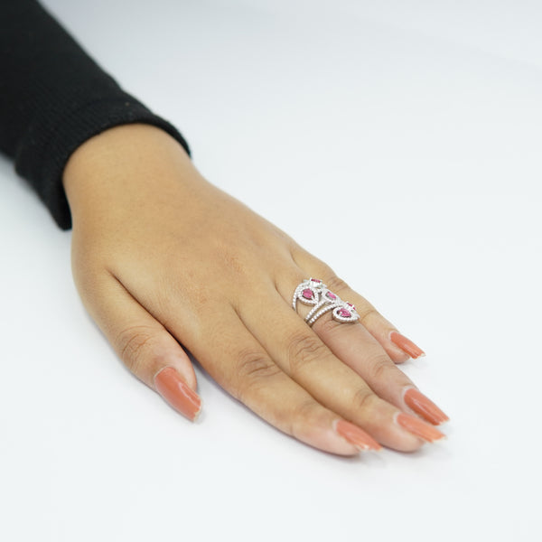 Sterling silver adjustable butterfly ring with pink teardrop gemstones, elegant handcrafted jewelry for women displayed on hand with nude nail polish, designer fashion accessory.