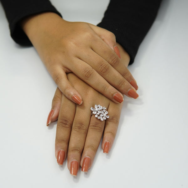 Silver floral cluster ring featuring marquise-cut and round zircon stones, luxury adjustable jewelry piece for women shown on manicured hands