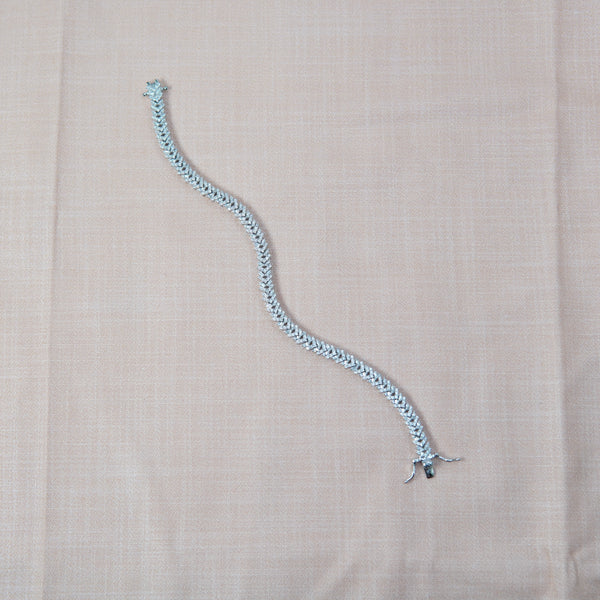 Silver diamond bracelet on a pink fabric background