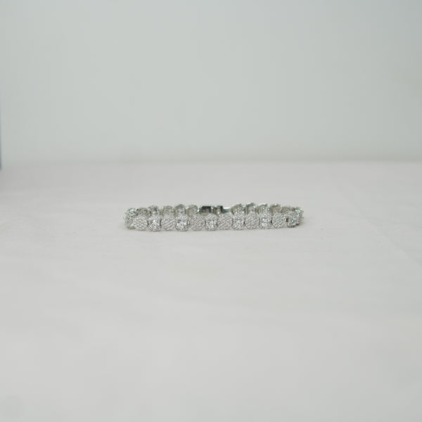 Silver bracelet with clear stones on a light gray background