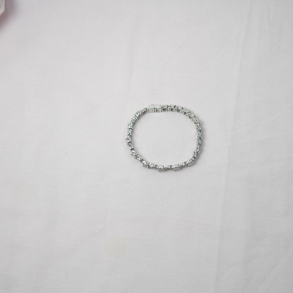 Silver bracelet on a light gray background
