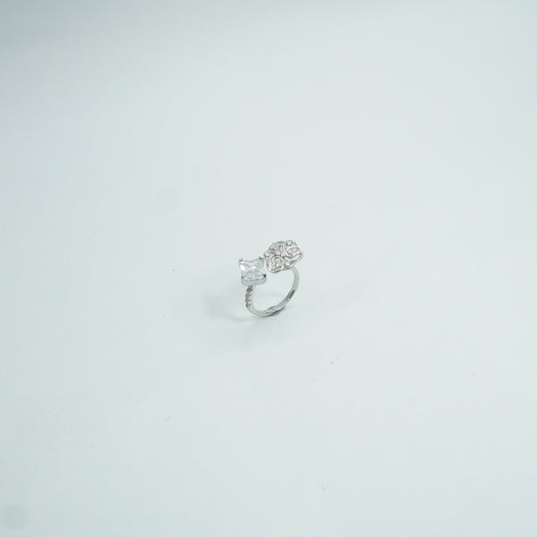 Luxury silver statement ring featuring square-cut crystal and floral diamond motif