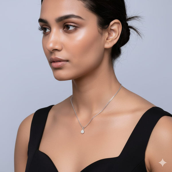 Woman wearing a silver necklace against a light gray background