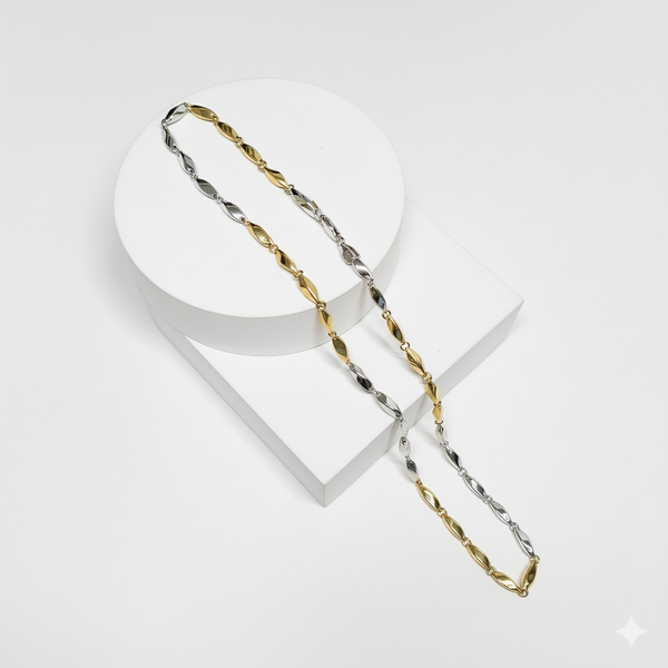 Gold and silver chain on a white stand with a white background