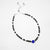 Silver Beaded anklet with black and blue beads on a white background