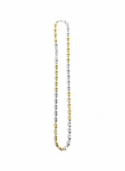 Two-tone gold and silver necklace on a white background