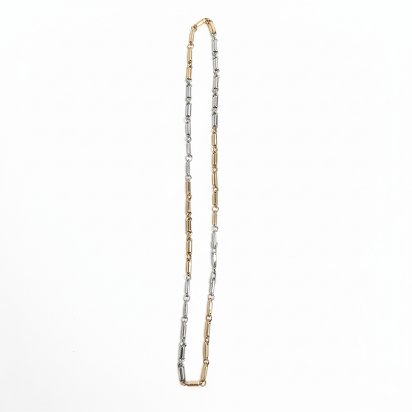 Two-tone gold and silver necklace on a white background