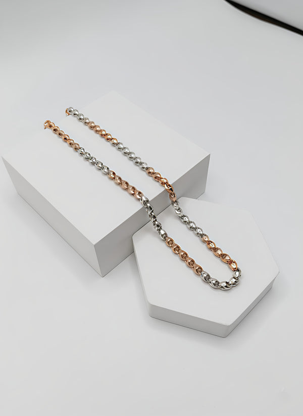 Two tone necklaces with silver and gold on a white geometric base