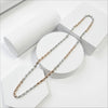Two tone necklace chain, one silver and one rose gold, on a white stand with a white background.