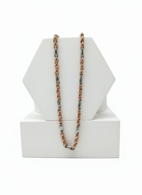 chain Necklace with rose gold and silver chain on a white geometric display stand